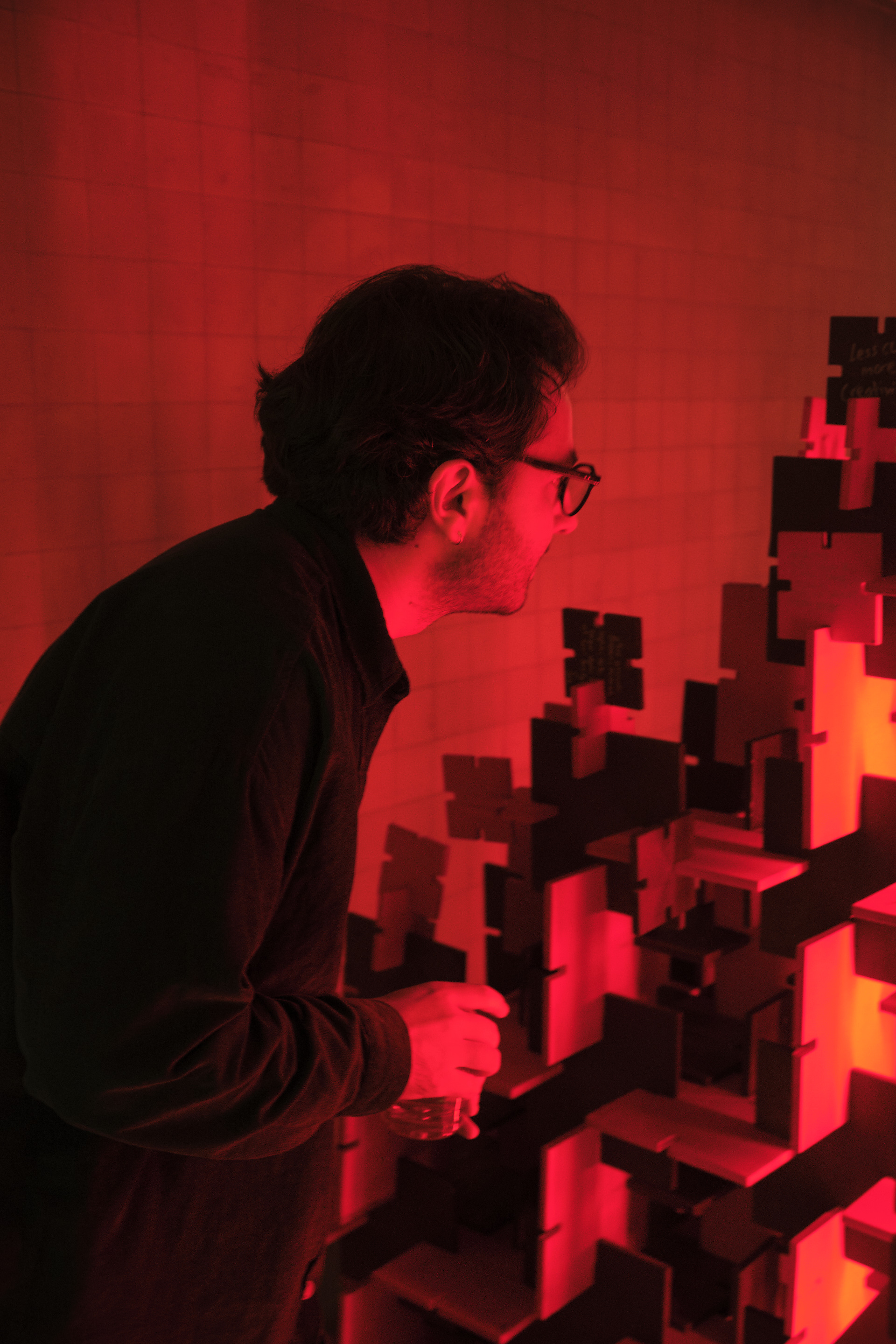 Visitor examining the illuminated modular tree — Bir Arada — Together, Istanbul