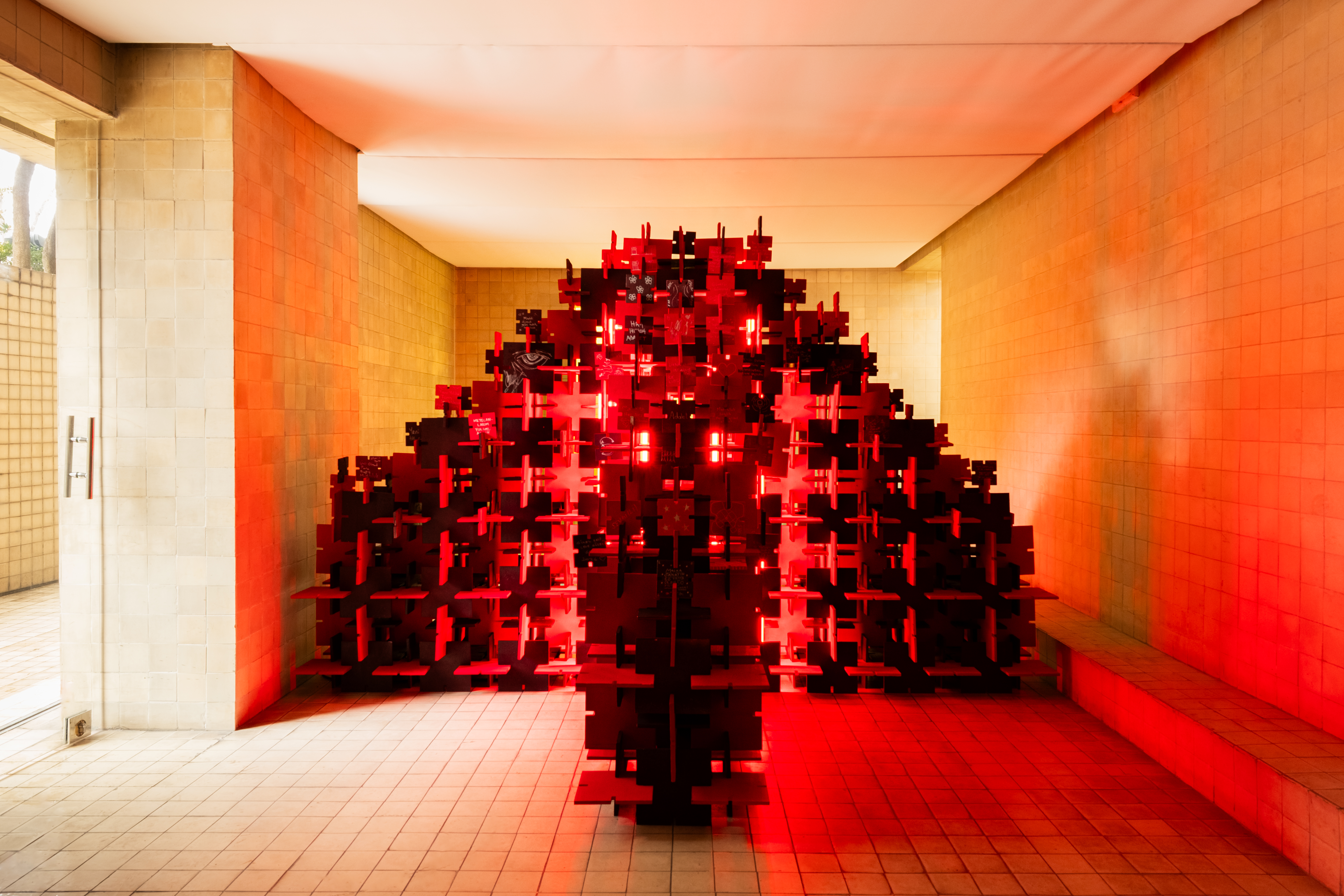 Modular red tree glowing inside the gallery — Bir Arada — Together by Folistudio