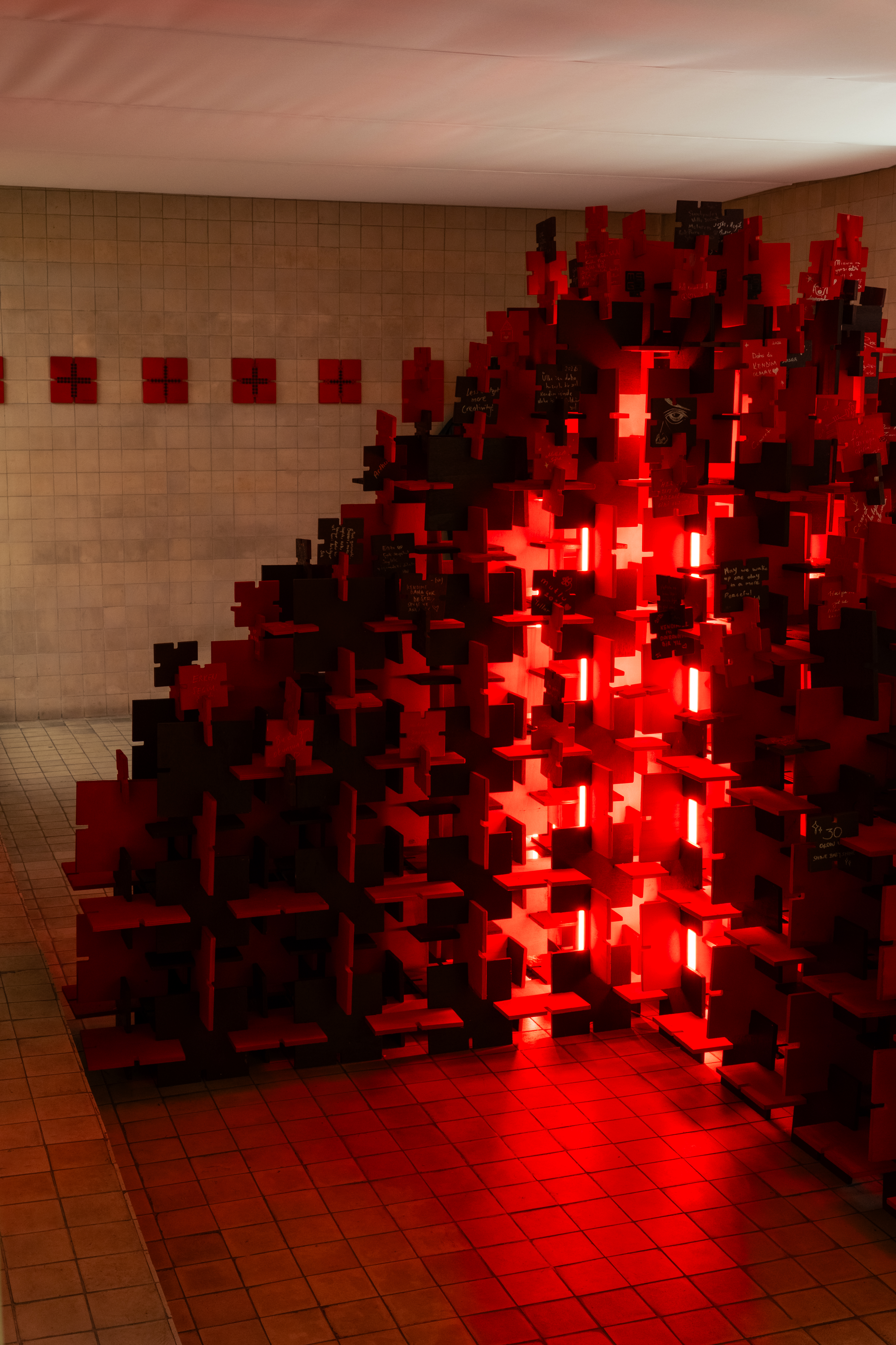 Pixelated red tree structure at the gallery threshold — Bir Arada installation