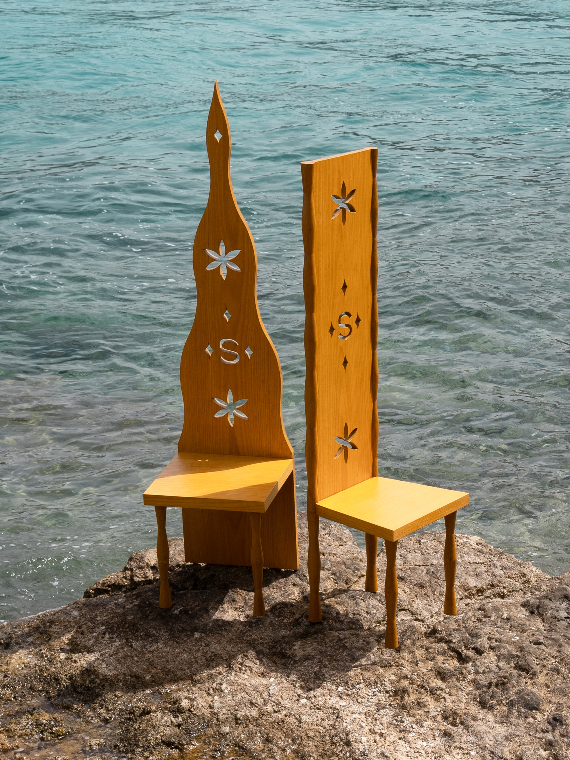 High-backed oak chairs with starfish cut-outs by the sea — Siedrés brand furniture