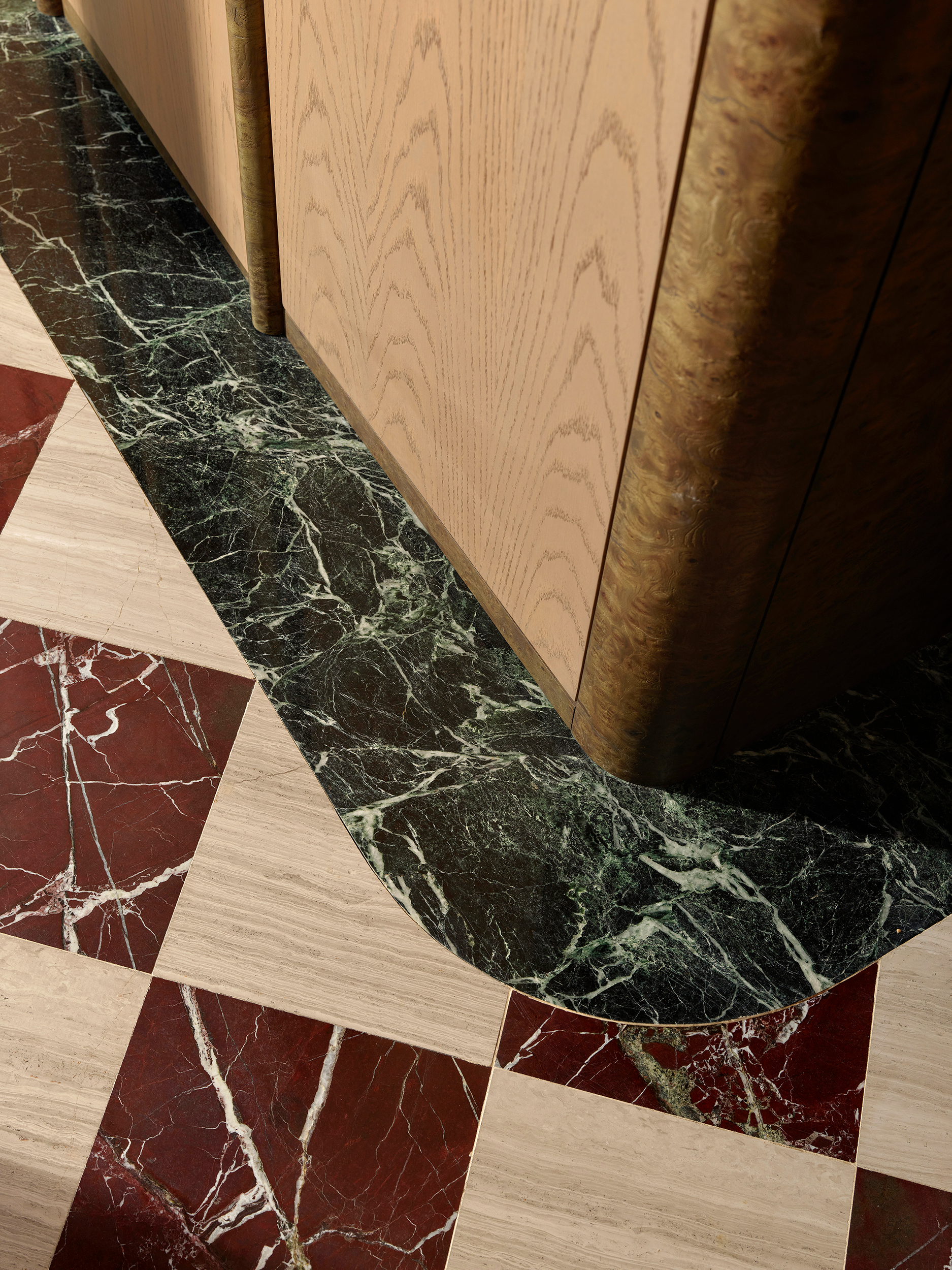 Green and red checkerboard marble floor meeting oak joinery — Zekeriyakoy TP House detail
