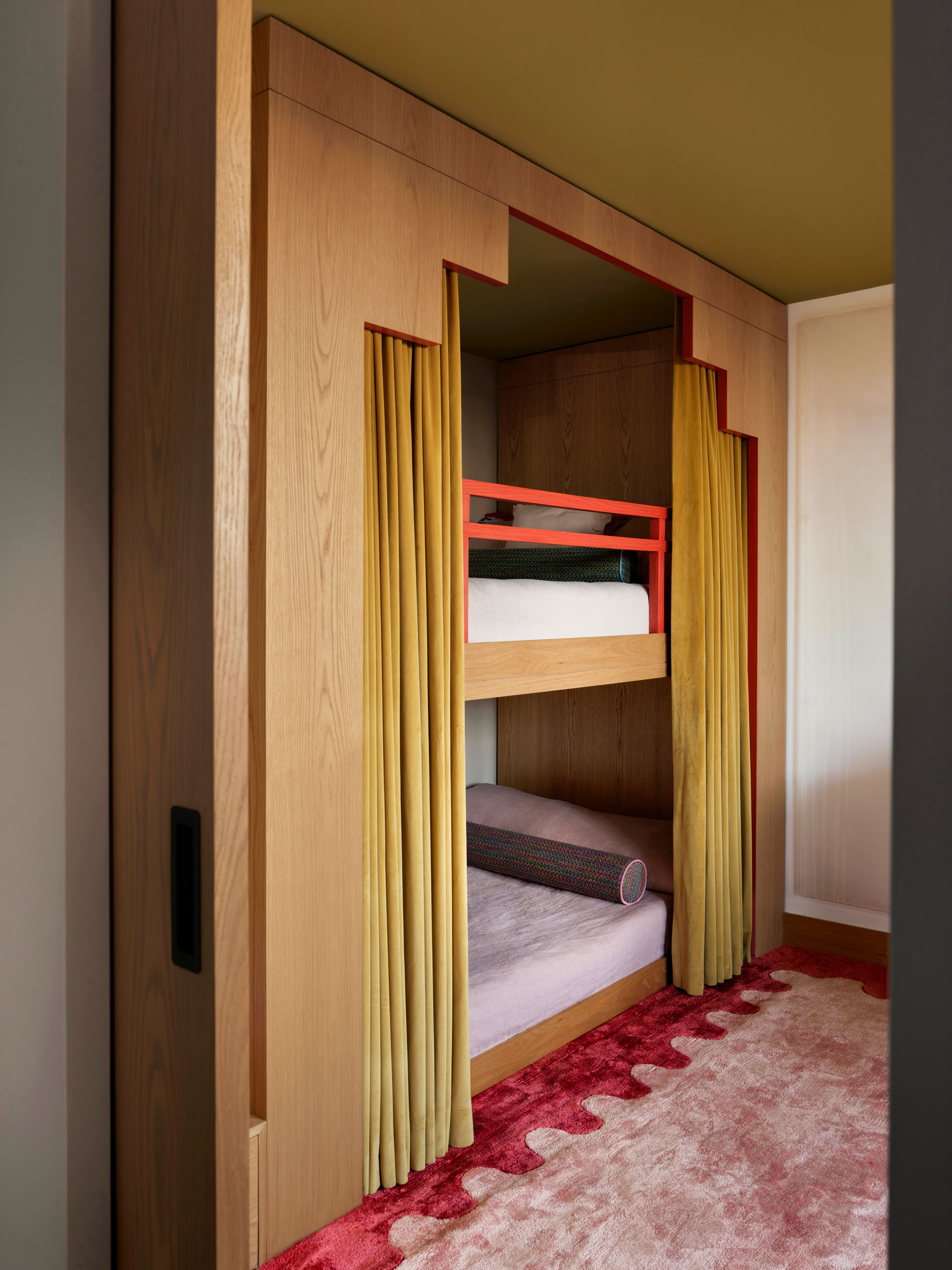 Children's bunk room with stepped oak joinery and red trim — Zekeriyakoy TP House