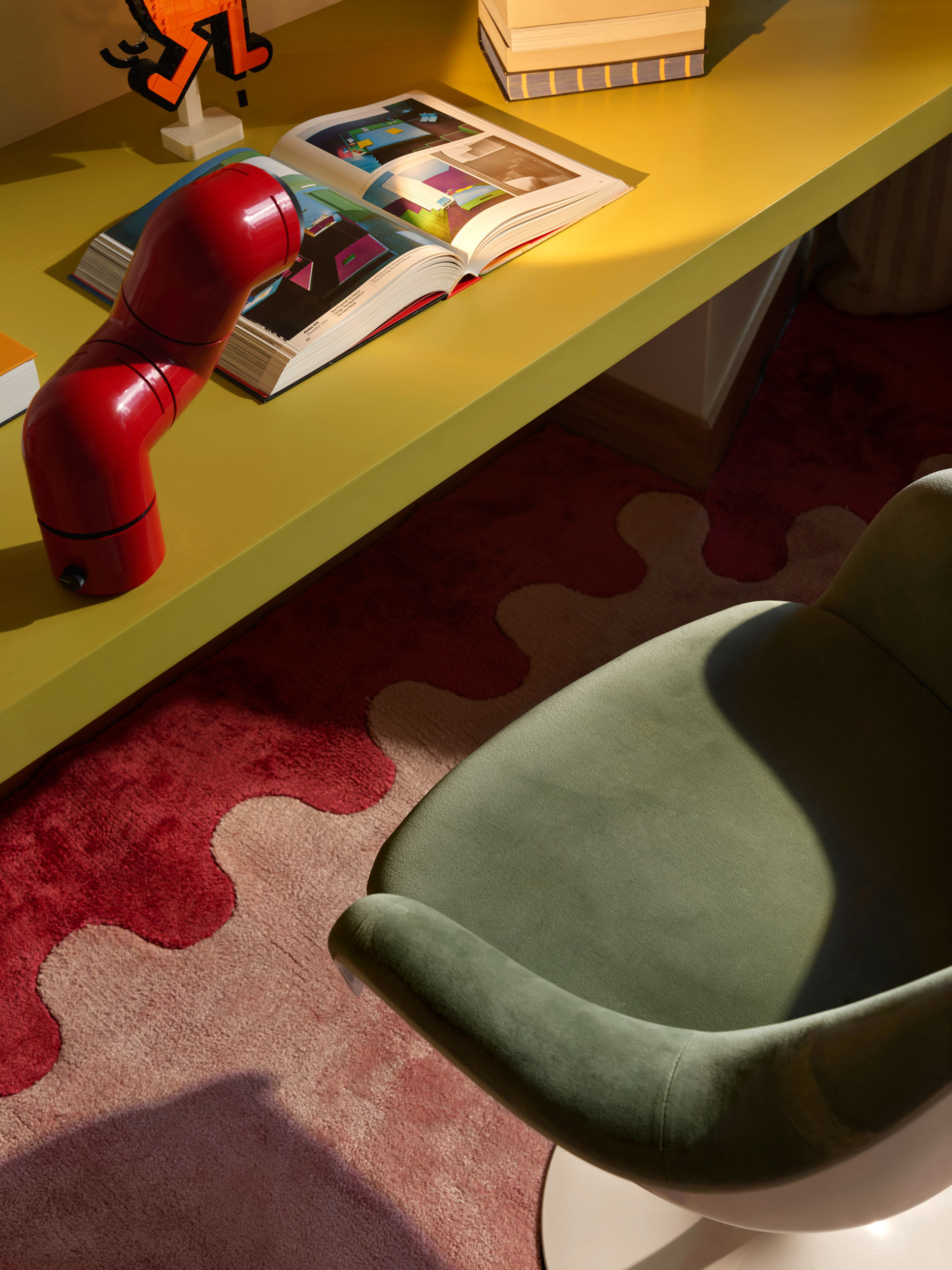 Yellow lacquered desk with red lamp and green velvet chair — Zekeriyakoy TP House study