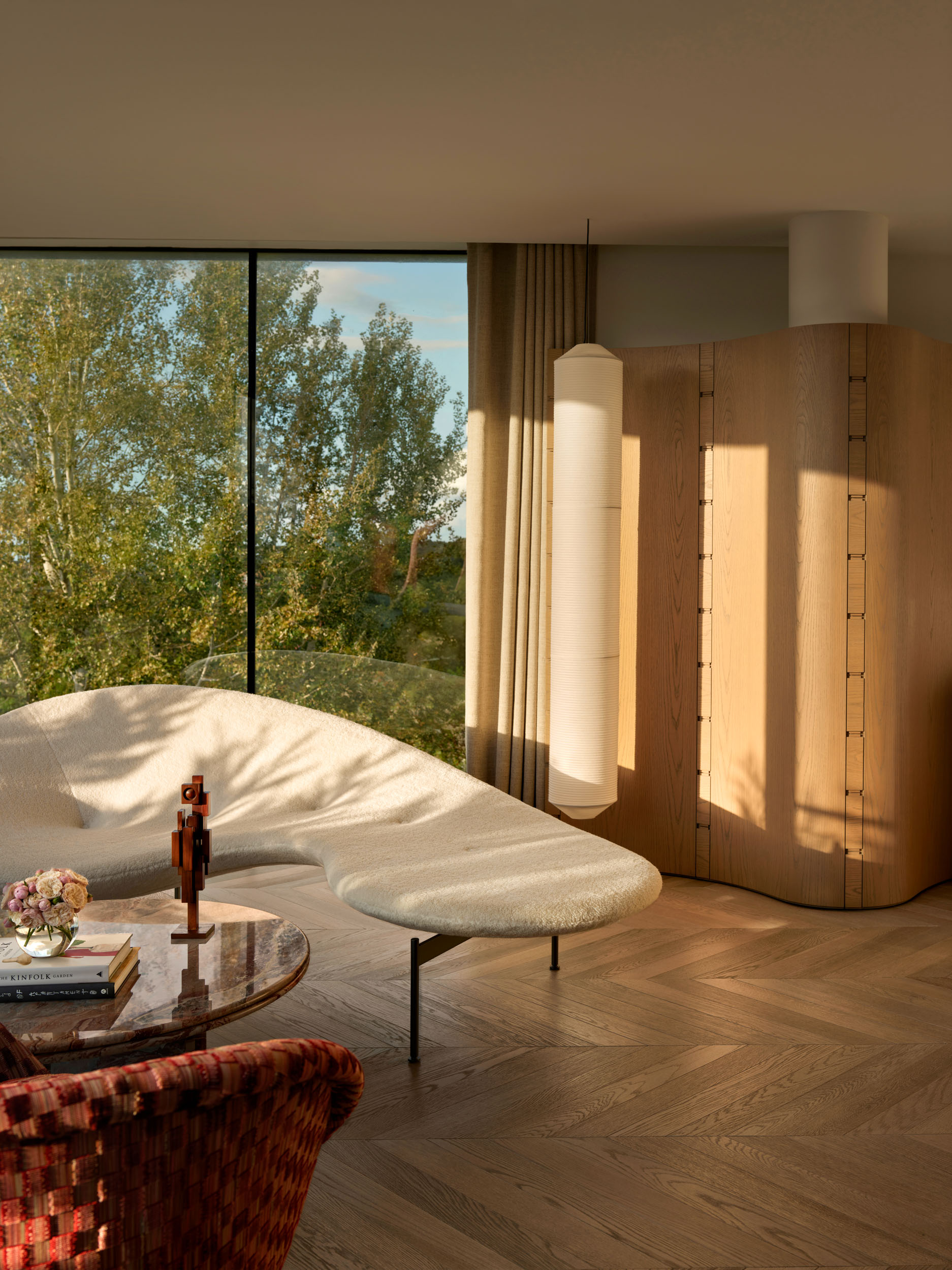 Cream sculptural sofa by a panoramic window — Zekeriyakoy TP House living space