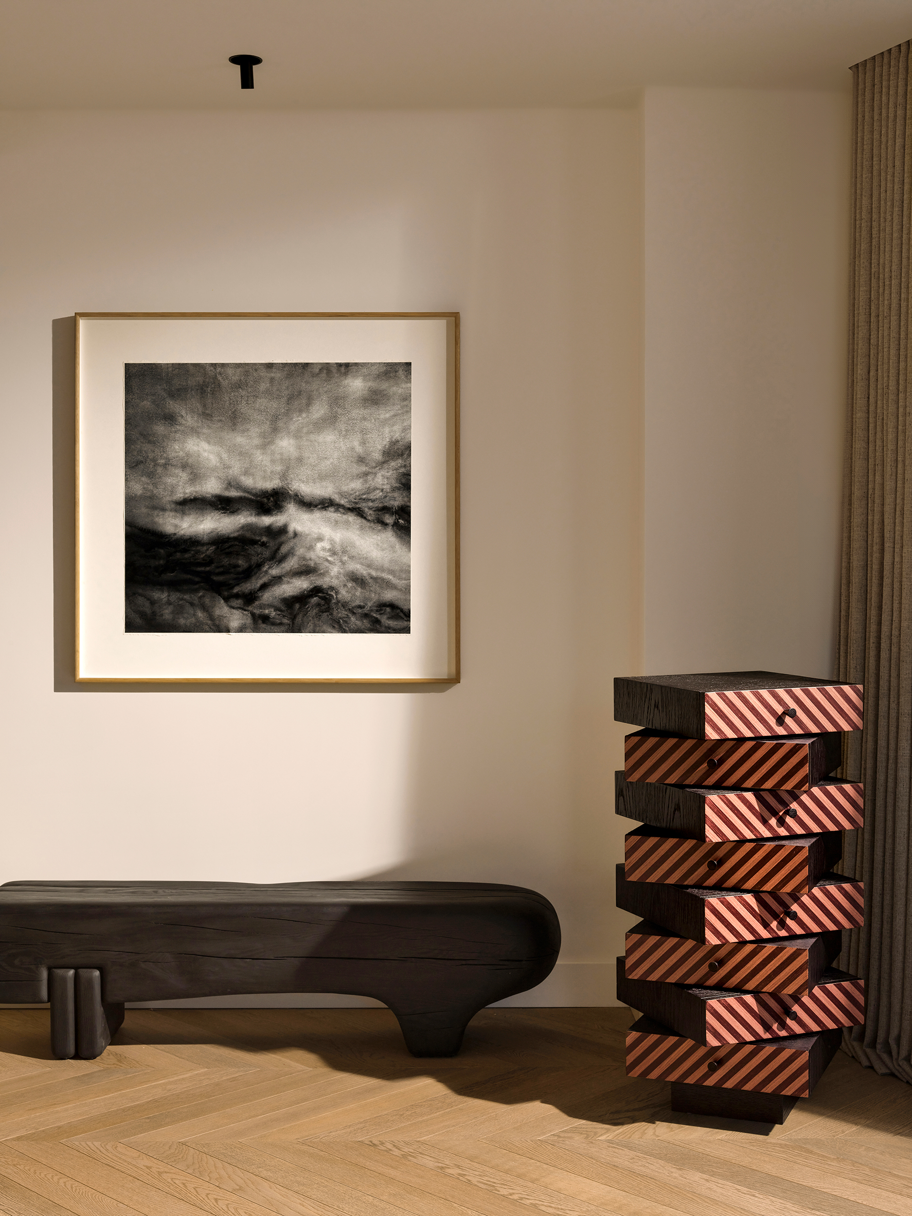Carved wood bench under a black-and-white seascape photograph — Zekeriyakoy TP House